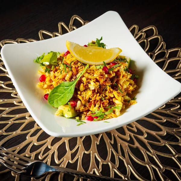 Paheli Modern Indian Cuisine's Bhel Puri, a savory snack with puffed rice, vegetables, and tamarind sauce.